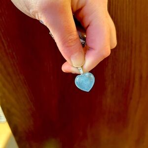 Aquamarine crystal carved heart pendant necklace on adjustable chain.